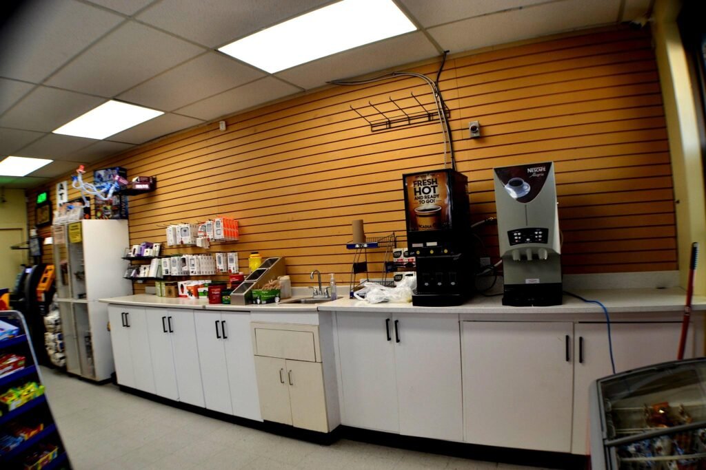 Convenience store counter with white cabinetry and slatwall