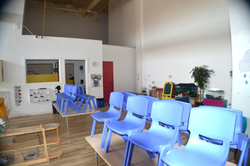 Munchkin Mansion interior with blue chairs and activity tables